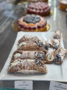 a tray of pastries on display in a display case at Lucca Charm in Lucca