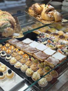 a display case filled with different types of pastries and bread at Lucca Charm in Lucca +22 photos