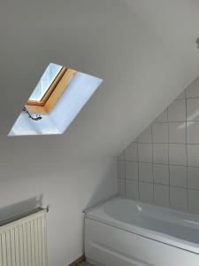 a bathroom with a window above a toilet at Camere de Inchiriat Ceahlau in Ceahlău
