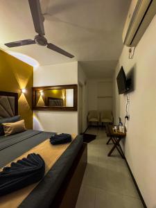 a hotel room with a bed and a television at Sky Garden Kandy in Kandy