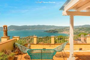 a balcony with chairs and a view of the water at Luxury Penthouse, Terre Marine in Lerici