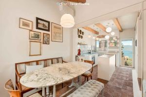 a kitchen and dining room with a table and chairs at Luxury Penthouse, Terre Marine in Lerici