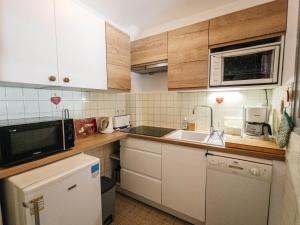 a small kitchen with white cabinets and a sink at Studio 2 pers. Sud avec balcon à Valloire - FR-1-263-53 in Valloire