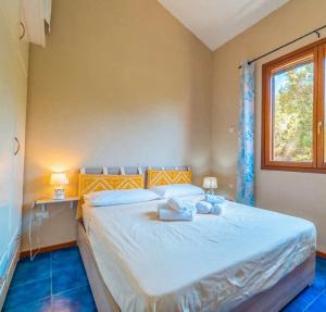 a bedroom with a bed with two towels on it at Le Terrazze di Porto Rotondo - Vista Mare in Porto Rotondo