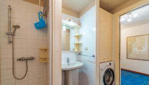 a bathroom with a sink and a washing machine at Le Terrazze di Porto Rotondo - Vista Mare in Porto Rotondo