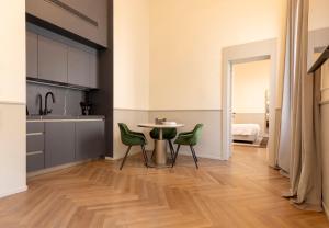 ヴェネツィアにあるLuxury Apartments Palazzo Naniのキッチン(テーブル、緑の椅子付)