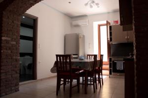 a kitchen with a table and chairs and a refrigerator at JP Castle Resort in Chios