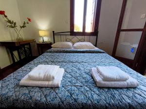 a bedroom with two beds with towels on them at JP Castle Resort in Chios