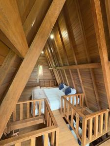 an attic bedroom with a bed in a log cabin at Langit Wanagiri in Gitgit