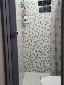 a bathroom with a shower with a toilet in it at Sossego Meu in Soure +11 photos