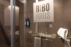 a bathroom with a sign that says bbo hotels at BIBO Hotel Recogidas in Granada +60 photos