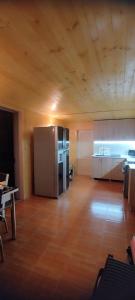 a large kitchen with a stainless steel refrigerator at ELENA HOUSE kONTUATI in Khoni +58 photos