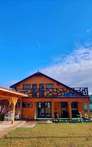 a large house with a large balcony on top of it at La Cheile Plaiului 