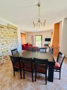 a dining room with a table and chairs at Mani Spot Sunset View in Areopoli +40 photos