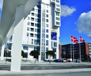 a tall white building with flags in front of it at Tivoli Hotel in Copenhagen