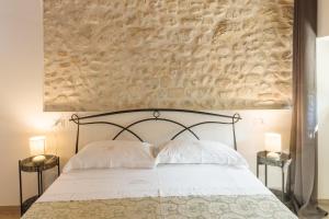 a bedroom with a white bed with two night stands at Le Camere di Stefano - Spoleto in Spoleto