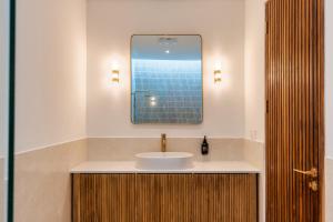a bathroom with a sink and a mirror at Villa Valli 8, Luxury Mediterranean Villa Bingin in Uluwatu
