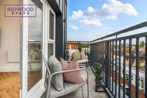 a balcony with a bench and a sign that reads redwood stays at Brand New Premium Serviced Apartments, Free Parking, High-Speed WiFi By Redwood Stays in Cove