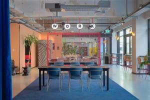 a conference room with a table and chairs in it at The Social Hub Bologna Extended Stay in Bologna +25 photos