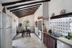 a kitchen with a table and a white refrigerator at Quinta Correio Mor 