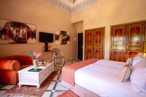 a bedroom with a large bed and a couch at L Mansion Villa in Najem