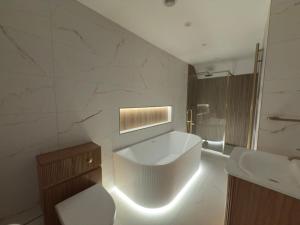 a white bathroom with a toilet and a sink at Peace Cottage in Darlington +30 photos