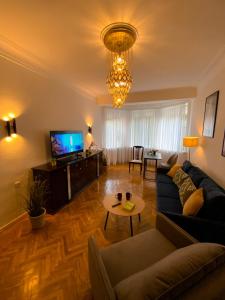 a living room with a couch and a tv at Kyiv Milano Apartment in Kyiv