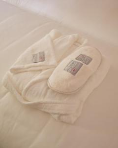 a white towel laying on top of a bed at Casa d'Abreu Neto - Siza's First Work in Matosinhos +36 photos