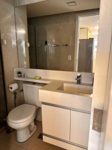 a bathroom with a toilet and a sink and a mirror at Maravilhoso flat 2 in Rio de Janeiro