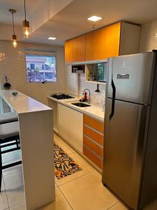 a kitchen with a stainless steel refrigerator at Maravilhoso flat 2 in Rio de Janeiro