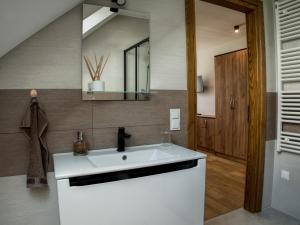 a bathroom with a white sink and a mirror at Apartamenty u Beci I Cyryla in Nowa Biała +55 photos