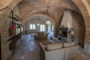 a living room with a couch and a fireplace at Podere Le Marene in Scoppieto