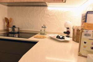 a kitchen with a counter top with a stove top oven at La casa di Nonna Afra in Agerola +47 photos