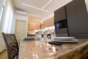 a kitchen with a long table with plates and glasses at La casa di Nonna Afra in Agerola