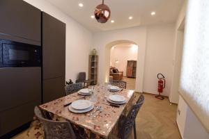 a dining room with a table with plates on it at La casa di Nonna Afra in Agerola