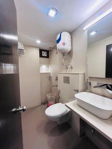 a bathroom with a toilet and a sink and a mirror at Edge Dwapar A Luxury Property Near Mall Road in Mussoorie