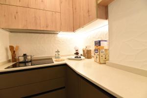 a kitchen with wooden cabinets and a counter top at La casa di Nonna Afra in Agerola