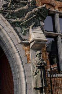 a statue of a man standing in front of a building at JAM Ghent in Ghent +62 photos