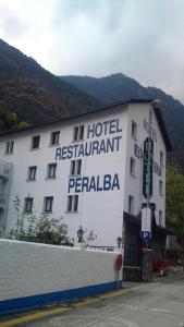 a hotel with a sign on the side of it at Hotel Peralba in Aixovall