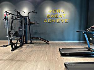 a gym with two treadmills and two exercise bikes at Your Comfy Samarahan Retreat in Kuching +5 photos