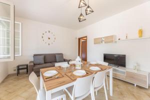 a dining room and living room with a table and chairs at Villa Dolcevivere in Specchiolla 