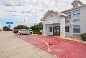 a car parked in a parking lot in front of a building at Studio 6 Fort Worth, TX - Meacham in Fort Worth +22 photos