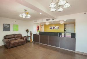 a waiting room with a couch and a counter at Studio 6 Fort Worth, TX - Meacham in Fort Worth