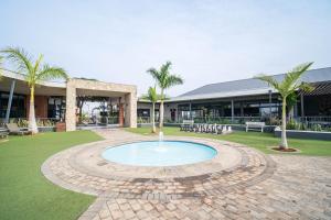 a fountain in a circle in front of a building at Ballito Hills 164 in Ballito