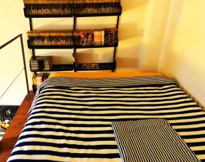 a room with a striped rug on a shelf at Loft Bovisa in Milan +5 photos