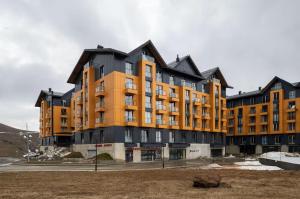 a large building with an orange and black at Kala Collection-Timber in Gudauri