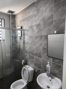 a bathroom with a toilet and a sink and a shower at De' Jamboree Homestay in Batu Gajah +12 photos