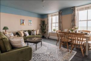 a living room with a couch and a table at Seaside Serenity 3-Bed Gem with Beach Views in Margate