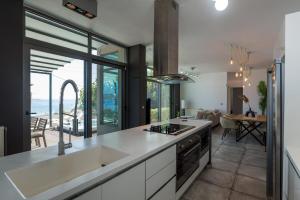 a kitchen with a sink and a stove top oven at Villa Seaview Serenity - Jacuzzi & Panoramic Views in Chania