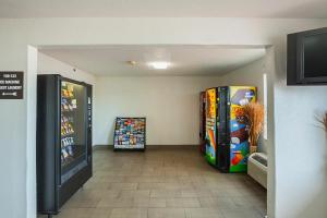 a room with two video game machines in it at Studio 6 Fort Worth, TX - Meacham in Fort Worth